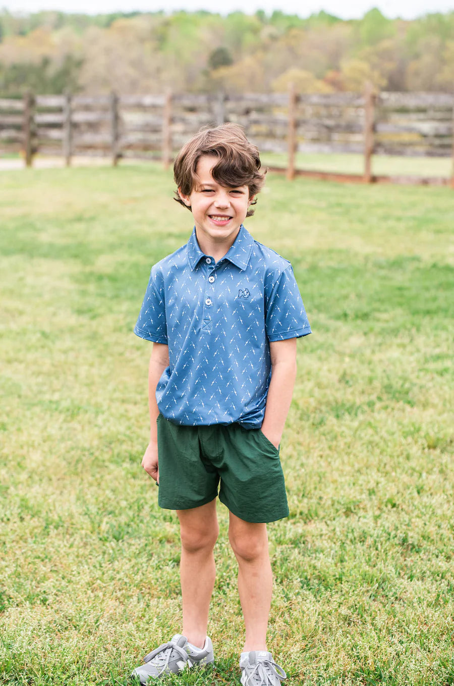 BOY'S SHORT SLEEVE PRO PERFORMANCE POLO IN FISHING ROD PRINT ON BLUE