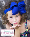 WHITE PANTYHOSE HEADBAND WITH 4.5 INCH BOW ATTACHED